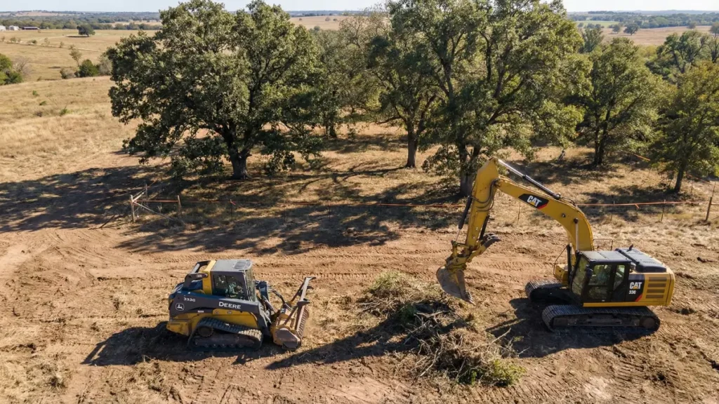 Selective land clearing in Texas removing brush and small trees while preserving larger trees for construction site preparation.